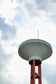 Concrete Water Tower Structure Under Cloudy Sky