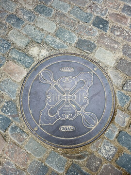 Copenhagen, Denmark - July 24, 2026: Close-up of a gully cover in Tivoli Gardens amusement park.
