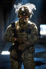 Obraz premium Armed Soldier In Tactical Camouflage Gear With Helmet And Rifle Standing In Dim Urban Environment