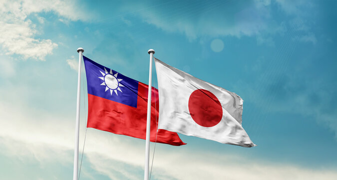 Taiwan and Japan friendship flags are waving in the sky. Two country flag for agreement or deal. Taiwan Japan national flag for commitment.