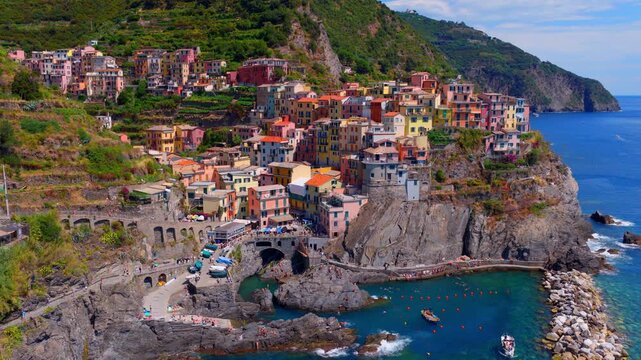 Daytime drone shot of Manarola village in Cinque Terre in Italy, Liguria, Italian Riviera aerial view, holiday in Italy