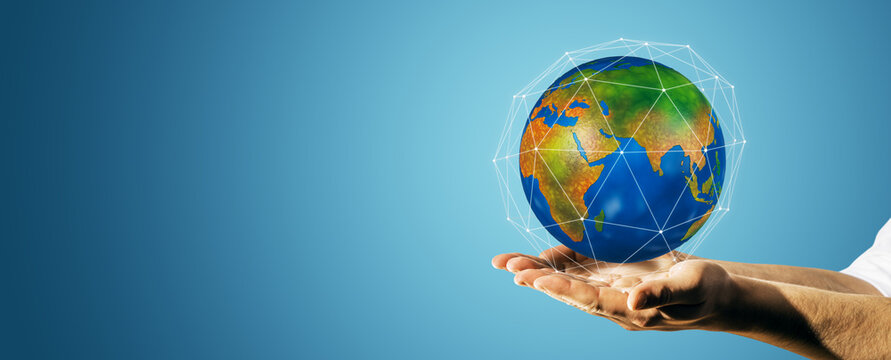 Global network world globe held in human hands with digital connection lines on blue background, clean copy space for worldwide business concepts.