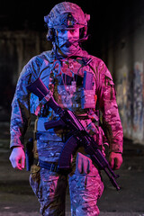 Obraz premium Armed Soldier In Tactical Gear Wearing Helmet And Camouflage With Assault Rifle In Urban Night