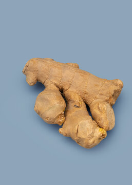 Ginger root placed on a light blue surface with a simple and clear arrangement
