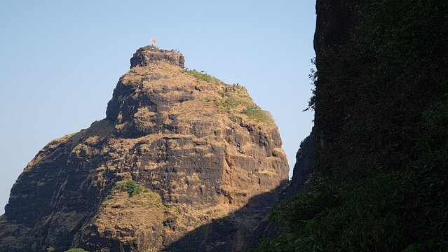 Kalavantin Durg pinnacle with trekkers climbing steep steps near Prabalgad Maharashtra India
