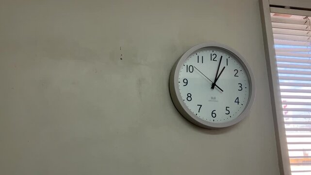 The wall clock at 1:00 PM