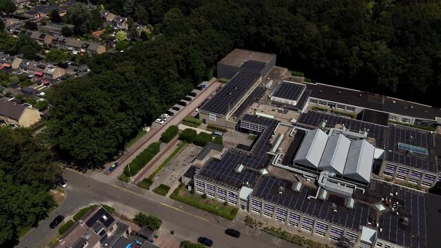 Aerial Drone View of RSG Slingerbos School Campus in Harderwijk During Summer Vacation rotating with neighborhood