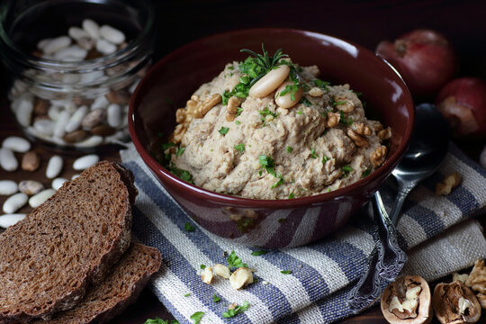 White bean paste, gourmet plant-based white navy bean pate appetizer from above with blank text copy space on a dark textured surface