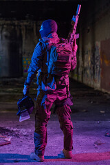 Fototapeta premium Tactical Medic Soldier With Rifle In Neon Urban Abandoned Building At Night Portrait