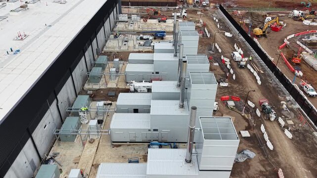 Aerial view of a data center construction site with power generators