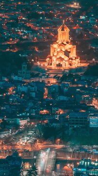 Tbilisi, Georgia. Elevated top Scenic View Famous Landmark Sameba Church In Evening. Georgian Capital Skyline Cityscape Night Time lapse timelapse