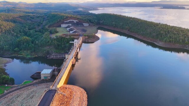Aerial video flying over Lake Keepit Dam and the surrounding landscape in NSW, Australia. The expansive reservoir, dam wall and rolling countryside