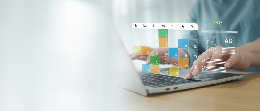 Woman using calendar on computer to organize her schedule at work ,  typing spreadsheet or schedule, agenda and reminder in office administration.