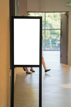 blank framed sign in front of boutique shop
