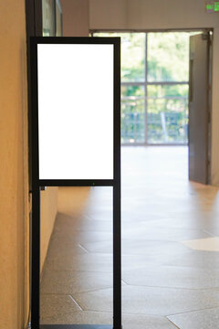 blank framed sign in front of boutique shop