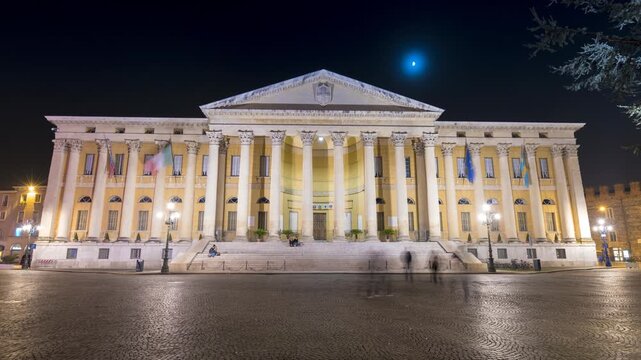Night timelapse of Palazzo della Gran Guardia in Verona showcasing the illuminated neoclassical architecture on Piazza Bra under a clear evening sky.