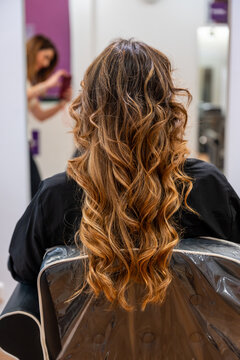 Woman getting hair styled at hair salon