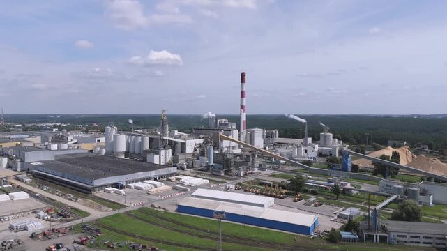 Aerial view of a large pulp and paper mill factory, wood chips storage, industrial manufacturing, and sustainable forestry production