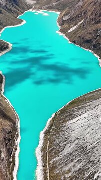 Aerial drone view of the turquoise waters of Laguna Par&oacute;n, with snow-capped peaks of the Cordillera Blanca in Huaraz, Peru.	