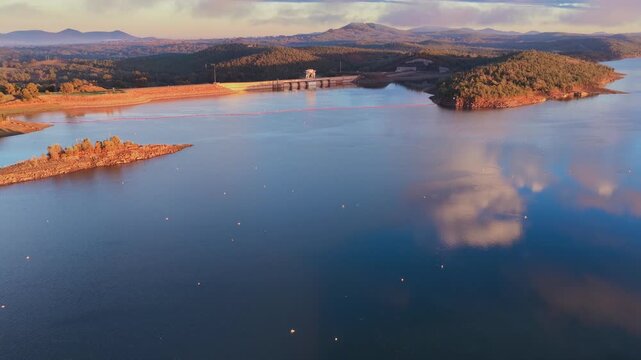 Aerial video flying over Lake Keepit Dam and the surrounding landscape in NSW, Australia. The expansive reservoir, dam wall and rolling countryside