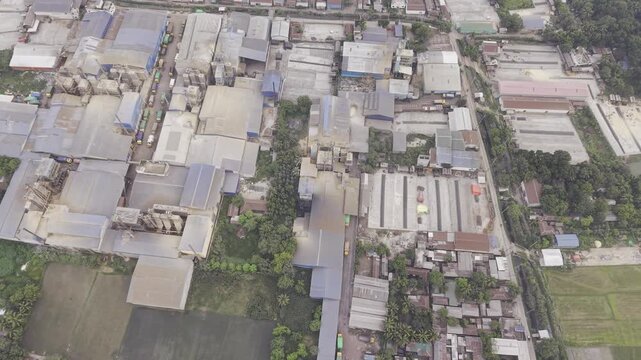 Drone footage with a lateral left movement over an industrial zone in Khajanagar, Kushtia, featuring factories, production buildings, infrastructure, and a rural-industrial landscape.