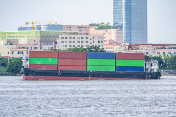 Naklejka premium A container ship on the Xijiang River in Zhongshan City, Guangdong Province, China.