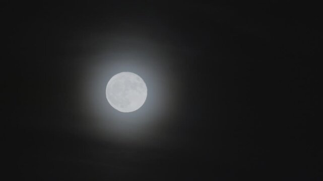 Full moon - super moon moves through the night sky.