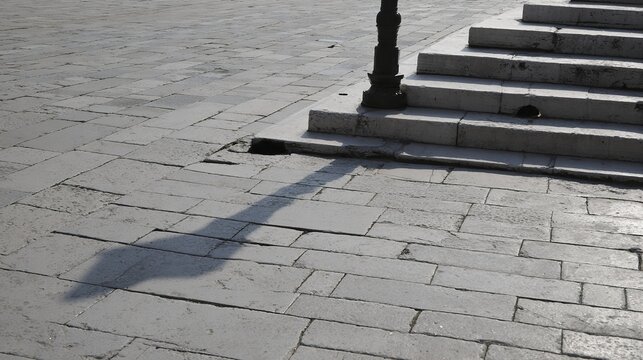 indentations. Empty ancient market square with stone steps showing indentations where a pillory once stood. event programs, museum guides, designed for cultural heritage projects and event programs.