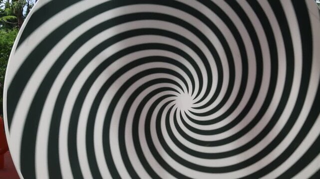 A rotating circle with stripes in the center. Illusion, fantasy, advanced technology.