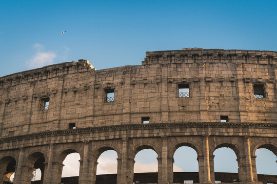 Colosseum, a UNESCO World Heritage site, showcases ancient Roman architecture with its iconic weathered stone facade and arches under a clear blue sky, symbolizing enduring historical legacy