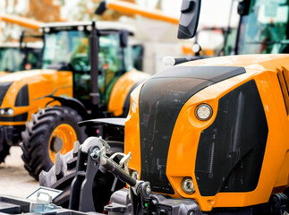 Fototapeta premium Agricultural tractors at dealership lot
