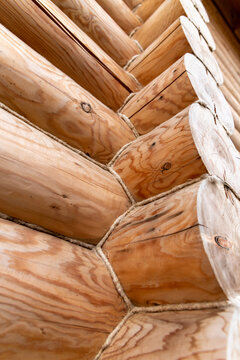 Construction work on a wooden house shows log details and textures