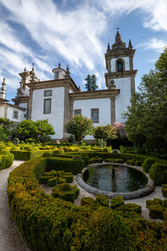 Gardens with ornamental hedges at the Mateus Palace in Vila Real, Portugal, on a sunny day.
