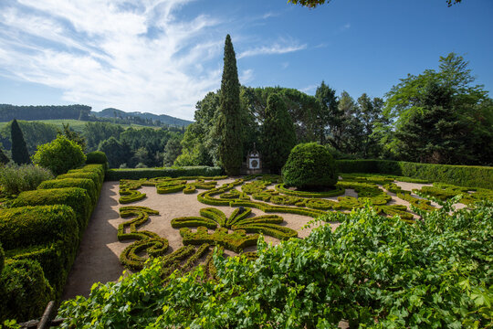 Gardens with ornamental hedges at the Mateus Palace in Vila Real, Portugal, on a sunny day.