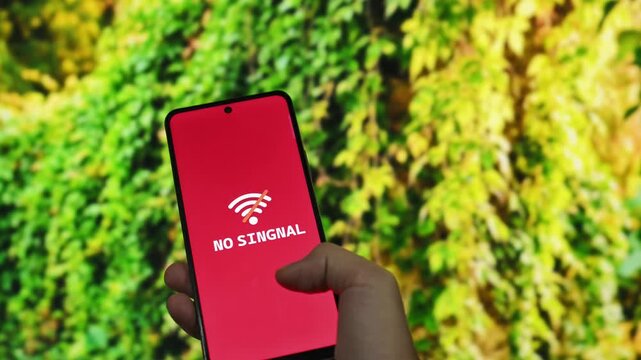 A hand holding a smartphone with no no signal