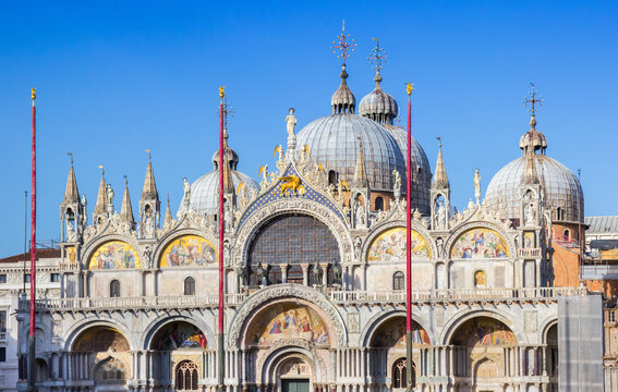 Ornate details and golden mosaics adorn the facade of the San Marco basilica in Venice, Italy