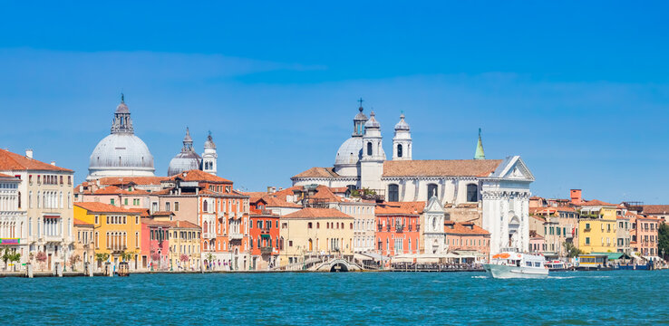 Domes of Salute and Gesuati churches rise above the Zattere waterfront skyline of Venice, Italy