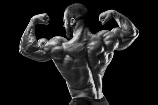 Muscular man showing back muscles, isolated. Strong male rear view