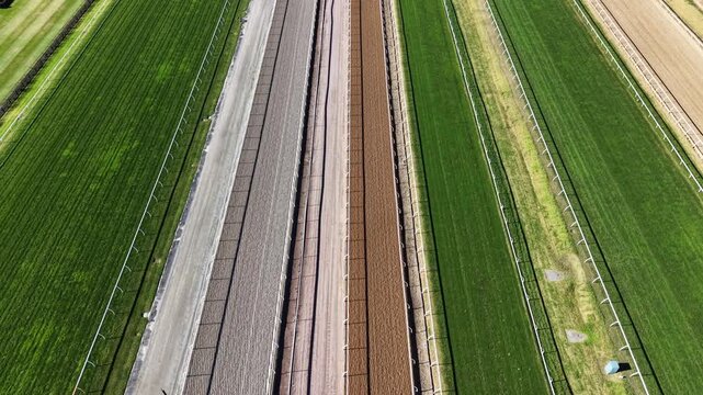 Drone flying over green horse racecourse track