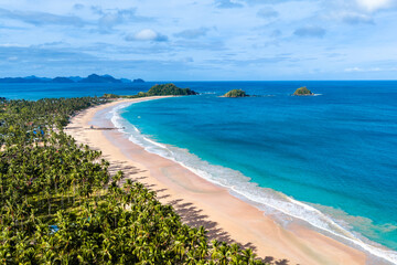 Aerial view of Nacpan beach with perfect sand and palm trees on the island of Palawan in the Philippines  © Donald