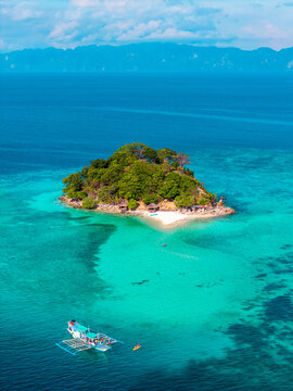 Aerial view of sand bars, shallow azure blue waters and tropical islands in the Philippines