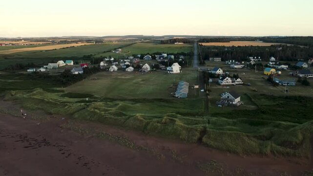 An aerial view of rural coastal homes and green fields on Prince Edward Island, Canada