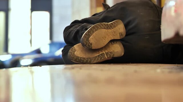 Homeless person sleeping on the street, struggling with urban poverty and social issues