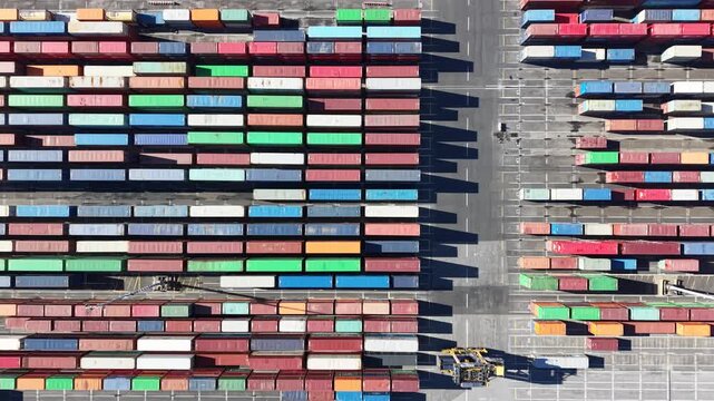 Reach stacker moving containers in a commercial port terminal