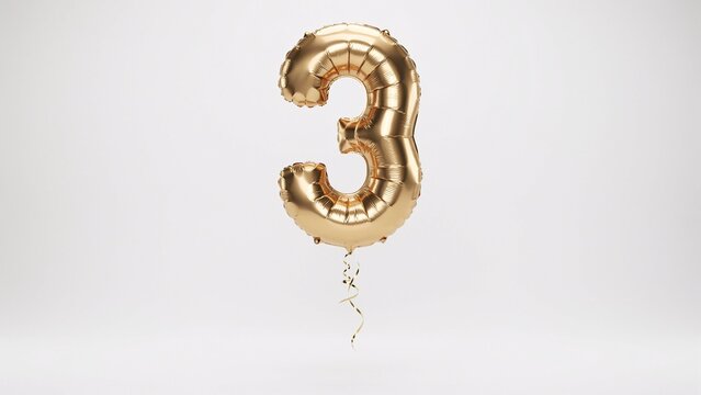 Gold foil balloon in the shape of the number three, isolated on white