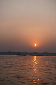 Golden sunrise reflecting across the Ganges River in Varanasi