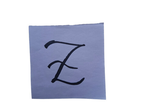Handwritten black ink cursive letter z on a white square paper , isolated.keywords: letter