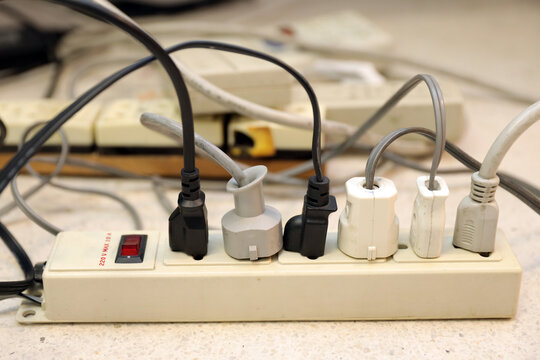 Old electrical extension cords plug is broken case damage and danger or connector voltage power burnt overload