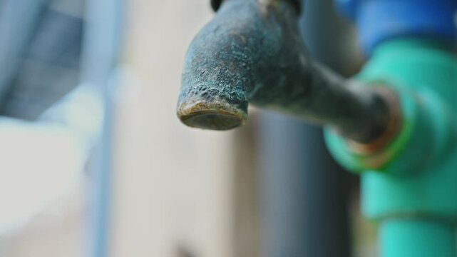 Close Up of Outdoor Water Tap Connected to PVC Pipe