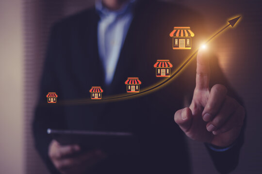 Businessman with franchise icon for goal to growth is investment planning financial and branch expansion and management bank loans for marketing franchising.